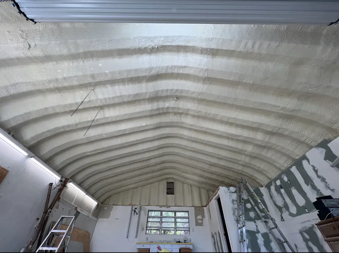 Spray polyurethane foam applied to the underside of a metal roof deck in Rock Island